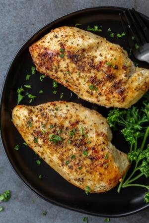 Chicken breast on a plate with herbs