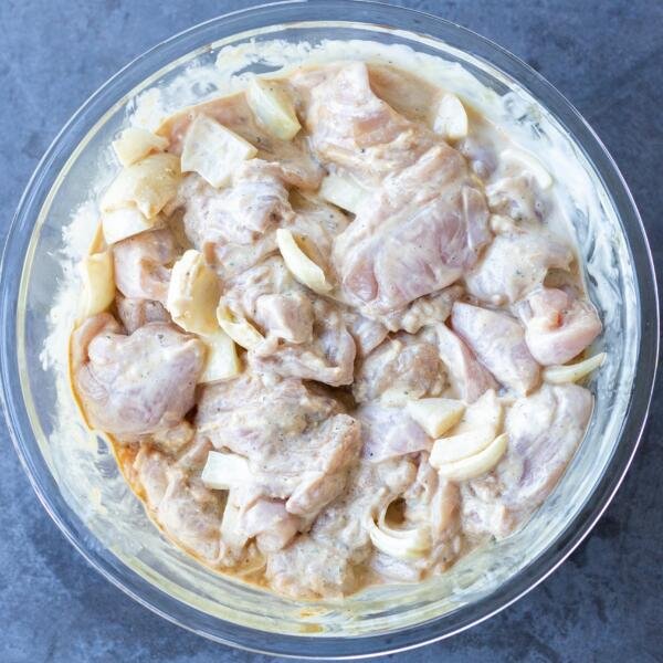 Chicken marinating in a bowl