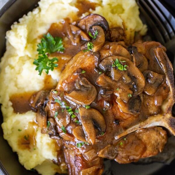 Pork with gravy in a bowl with potatoes