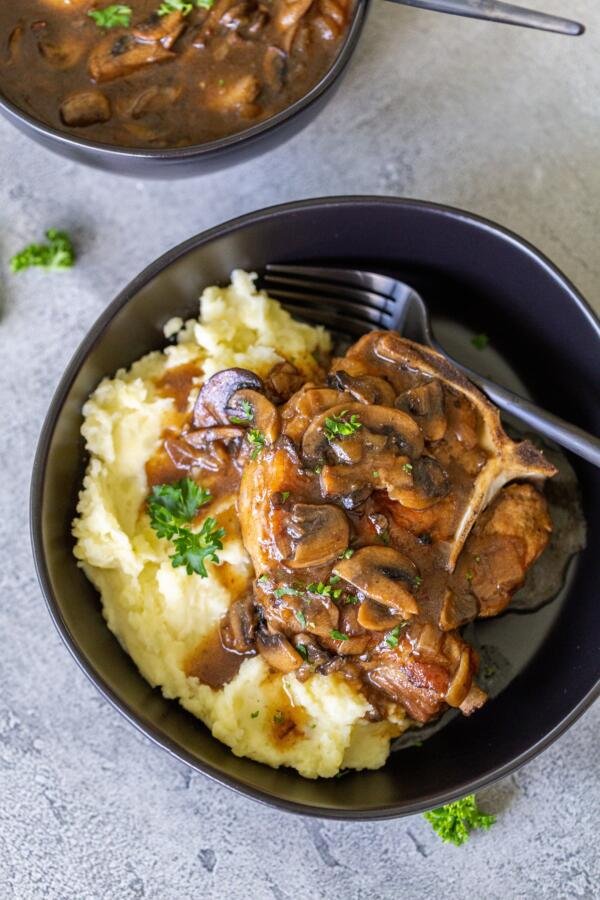 gravy with pork chops on a plate