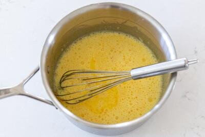 whisked egg yolks, condensed milk and water in a pot