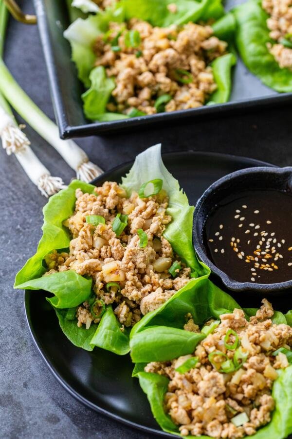 Chicken Lettuce wraps on a plate with sauce