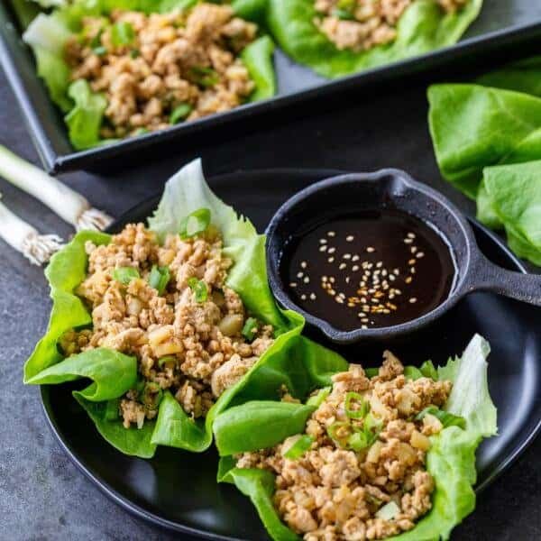 Chicken Lettuce wraps on a plate with sauce