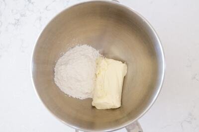 cream cheese and powdered sugar in a mixing bowl