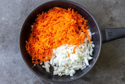 Carrots and onions in a frying pan