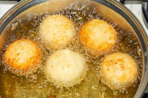 Deep fried donut holes in a pot