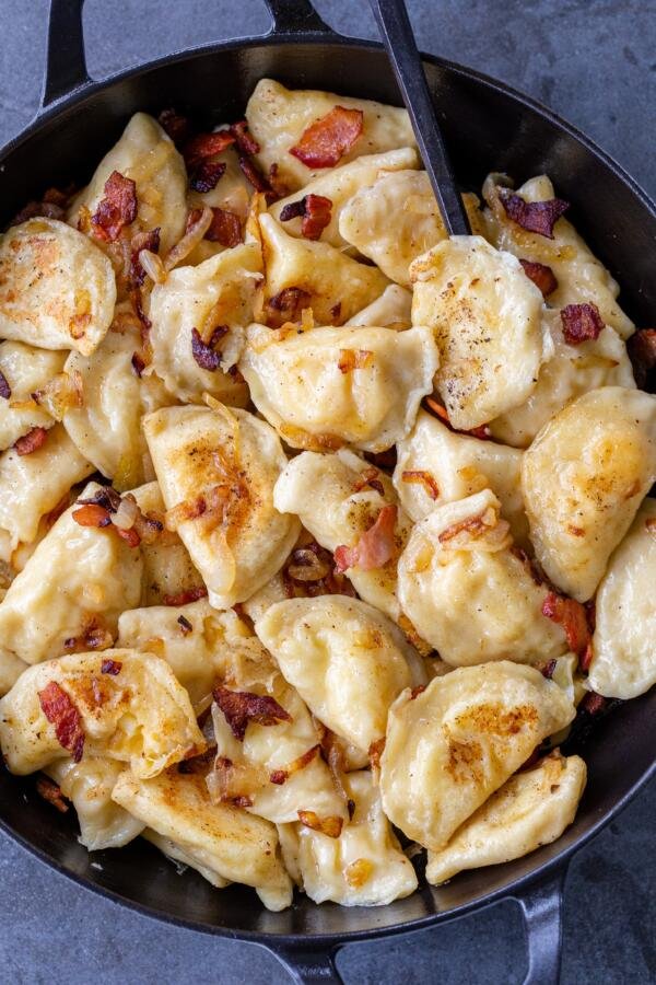 PIerogi with onion in a pan