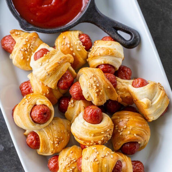 Baked pigs in a blanket on a serving tray