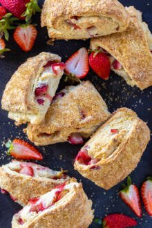 Strawberry scones on a serving tray with berries.