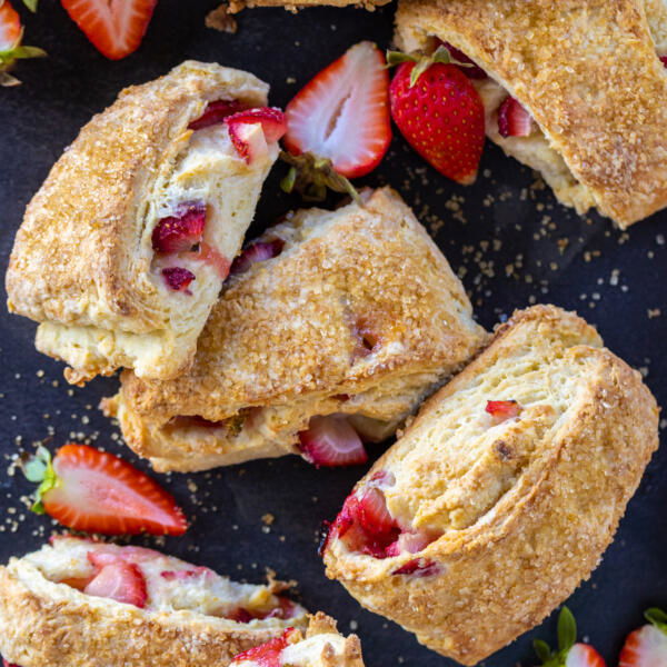 Strawberry scones on a serving tray with berries.
