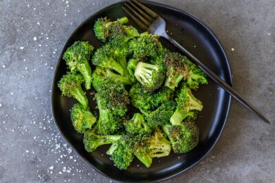 Broccoli on a plate with a fork