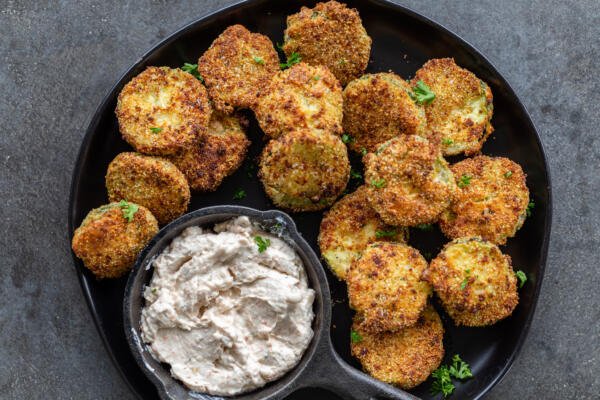 Air fryer parmesan chips on a plate with a dip