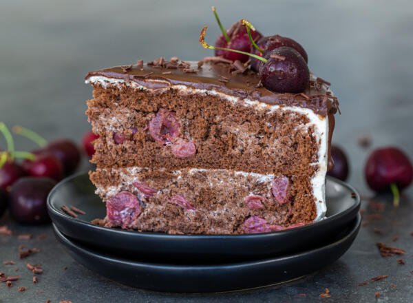 A slice of drunken cherry cake on a plate