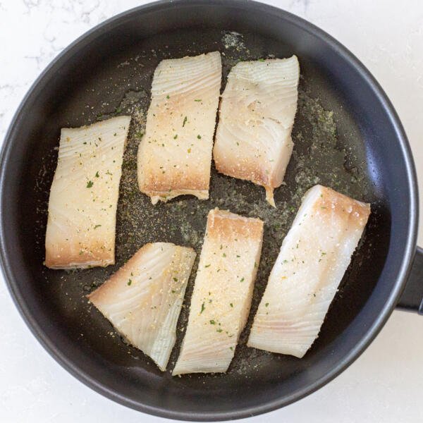 halibut cooking in a pan