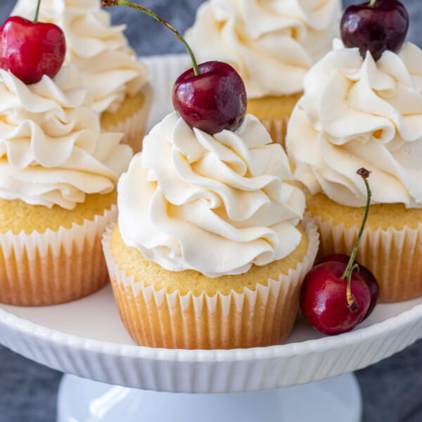 cupcakes on a cake stand with cherry