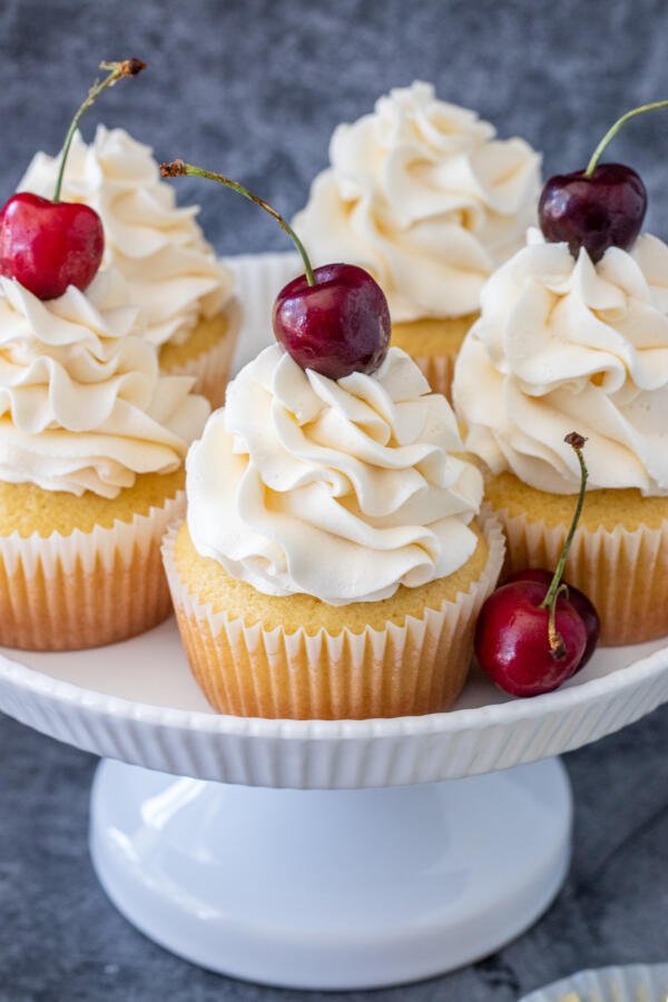 cupcakes on a cake stand with cherry