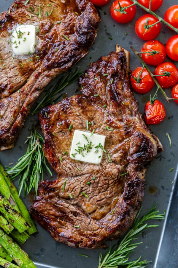 cooked ribeye with butter and veggies 