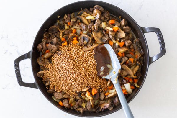 buckwheat added to the ingredients in a pan