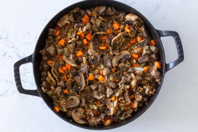 liquids added to buckwheat stew in a pan