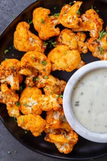 cooked cauliflower with buffalo sauce on a plate
