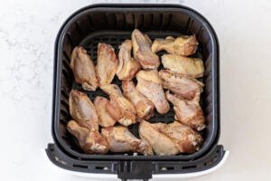 chicken wings in an air fryer basket