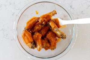 wings with buffalo sauce in a bowl
