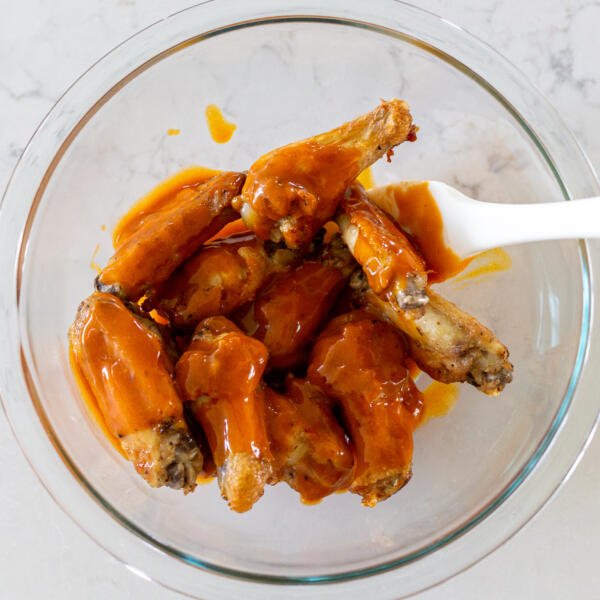 wings with buffalo sauce in a bowl
