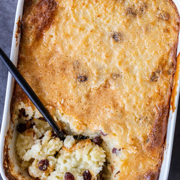Baked rice pudding in a pan with a serving spoon
