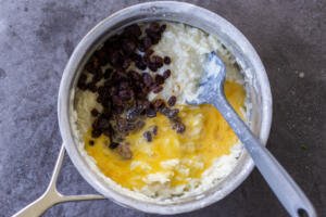 Eggs added to a pot with rice and raisins