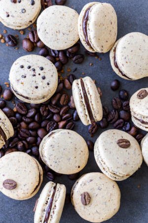 Coffee macarons on a pile of coffee beans
