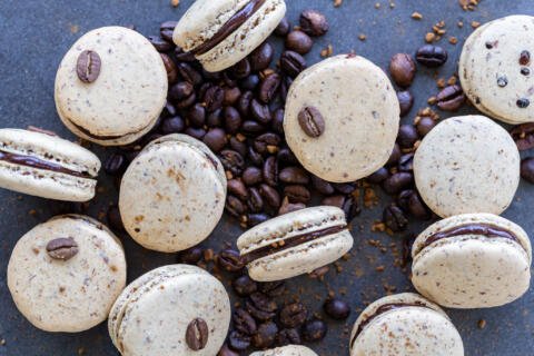 Coffee macarons on a pile of coffee beans