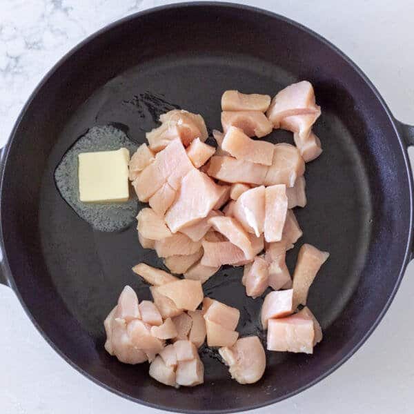 Chicken with butter in a pan
