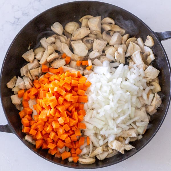 carrots and onion added in a pan