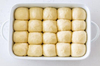 unbaked dinner rolls in a pan