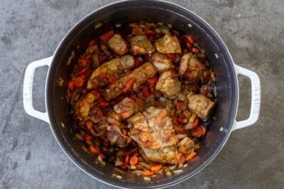 Pork, carrots and onion browned in a pot