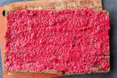 Mashed raspberries applied to cake.