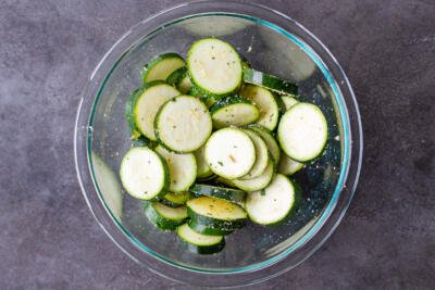 Bowl with zucchini slices and seasoning