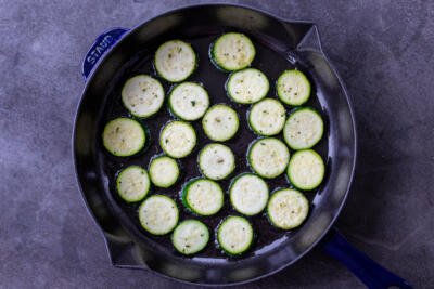 zucchini rings on a frying pan with oil