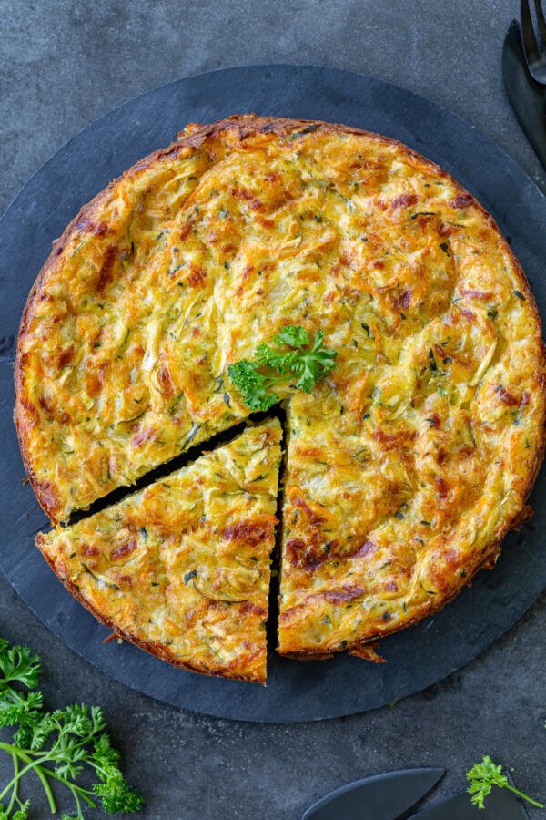 Savory zucchini casserole on a plate, sliced