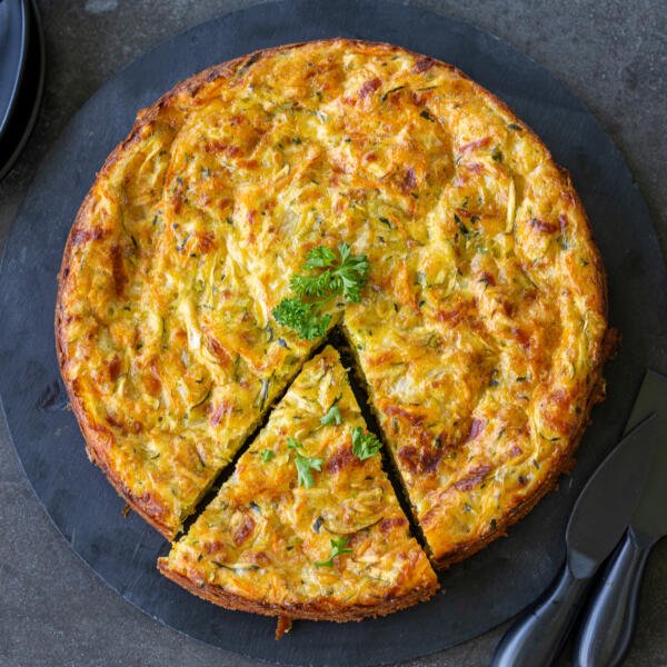 Savory zucchini casserole on a plate, sliced
