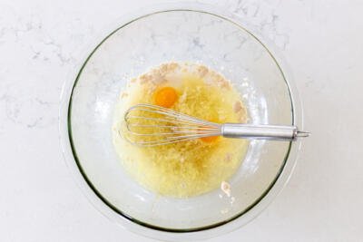 Liquids and yeast in a bowl and a whisk