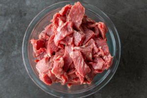 thinly cut steak in a bowl