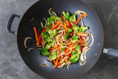 veggies frying in a wok