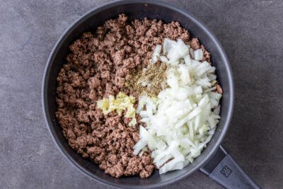 beef with onion, garlic and seasoning in a pan