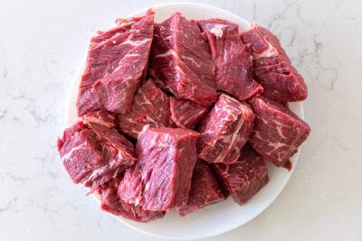 cut up beef into pieces on a plate