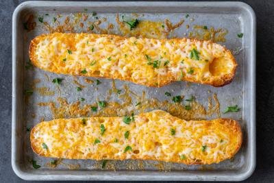Bread with melted cheese on a baking pan