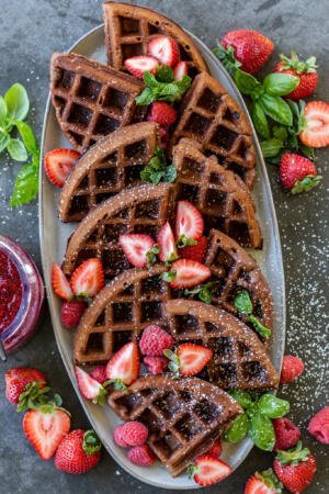 Pieces of Chocolate waffles on a plate with berries