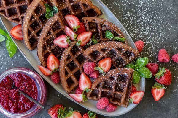 Pieces of Chocolate waffles on a plate with berries