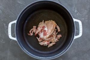 Bacon in a pot cooking.