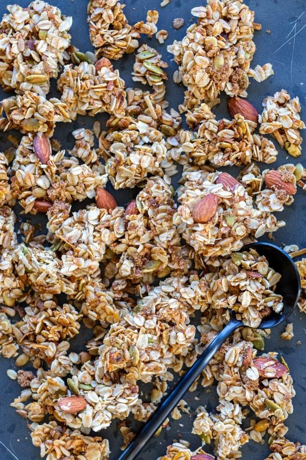 Broken down Coconut Granola Clusters on a pan